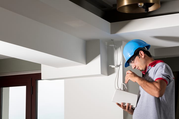 Palmetto Electrical Contractors | electrician installing a speaker