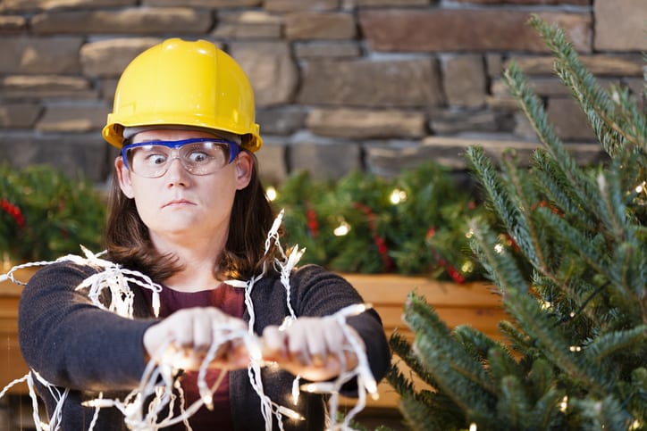 Palmetto Electrical Contractors | woman wearing a hardhat fixing Christmas lights