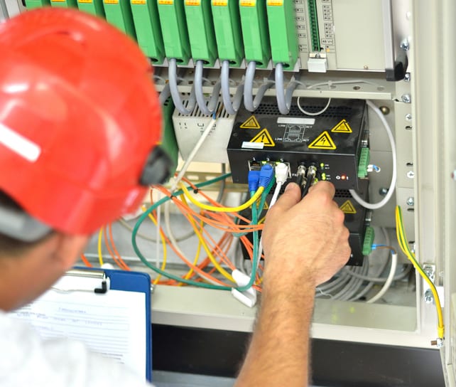Palmetto Electrical Contractors | engineer connecting fiber optic cable to the switch