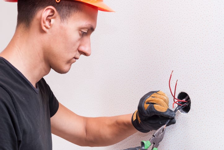 Palmetto Electrical Contractors | an electrician connecting wires
