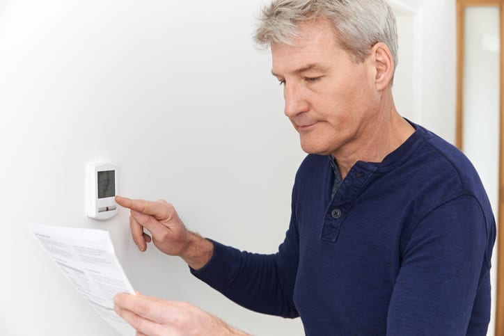 Palmetto Electrical Contractors | man adjusting a thermostat