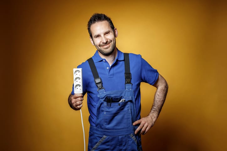 Palmetto Electrical Contractors | electrician with a power socket in his hand