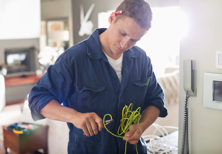 Palmetto Electrical Contractors | electrician cutting wires in a home